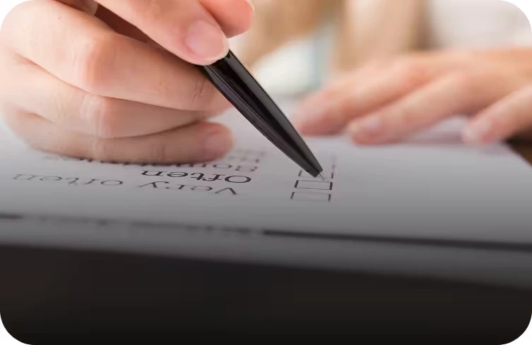 A person completing a printed onboarding checklist