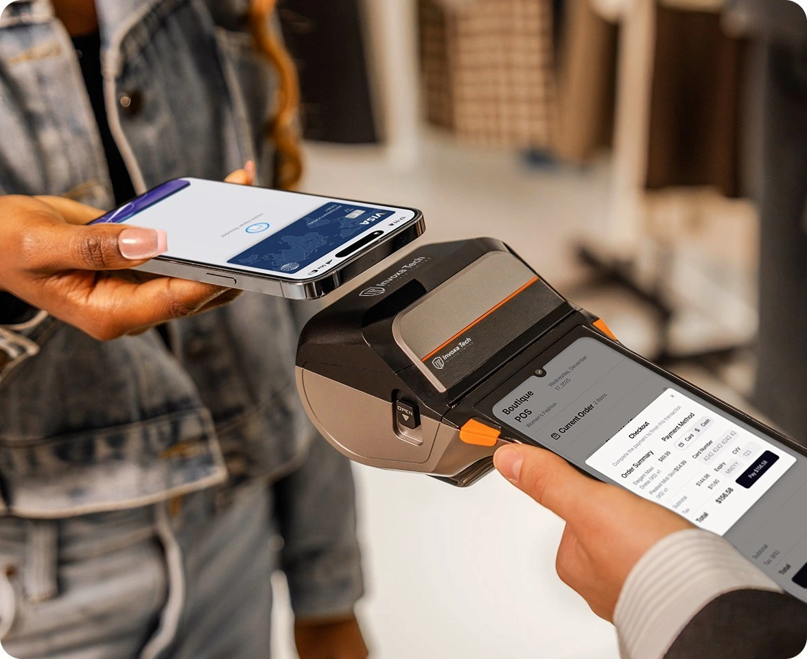 A business owner using a mobile phone with a POS terminal