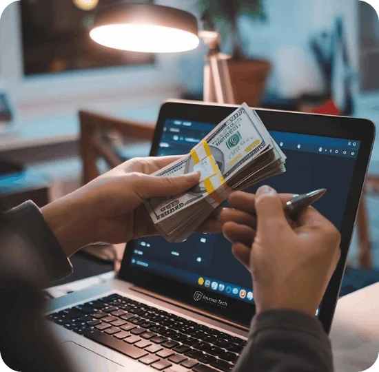 Business owner managing cash beside a laptop